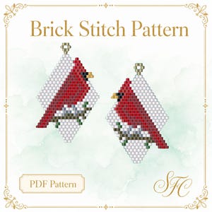 May include: A Brick Stitch Pattern PDF Pattern featuring two diamond-shaped beaded designs of red cardinals perched on branches against a white background. The design includes white, red, green, and brown beads with gold-toned metal loops.