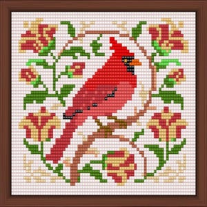 May include: Cross-stitch artwork of a red cardinal bird perched on a branch, surrounded by stylized flowers and foliage in shades of green, red, and yellow. The artwork is framed in a brown wooden frame.