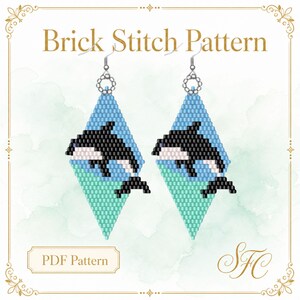 May include: A Brick Stitch Pattern PDF featuring a pair of diamond-shaped beaded earrings. The design displays a black and white orca whale swimming across a light blue and mint green background. Silver-toned earring hooks are attached at the top.