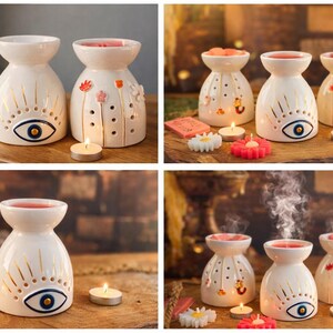 May include: Three white ceramic wax warmers with a flared top and rounded base. One features a blue and gold eye design, another has colorful floral accents, and the third has small dots. Each includes a hollow center for a tea light candle.