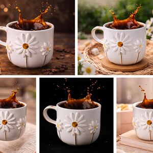 May include: A white ceramic mug featuring embossed daisy flower designs with gold-toned accents. The mug is filled with dark coffee, showing a dynamic liquid splash rising from the center. The handle has a gold-colored trim.