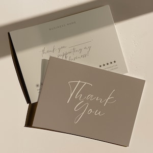 May include: A light beige thank you card with the words "Thank You" in elegant script. The card is on top of a matching beige box with the words "thank you for supporting my business!" and "BUSINESS NAME" printed on it.