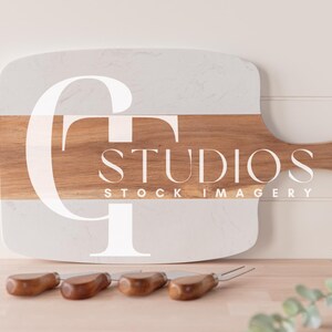 May include: A white and brown marble cutting board with a wooden handle. The board has the text "CT Studios Stock Imagery" printed on it.