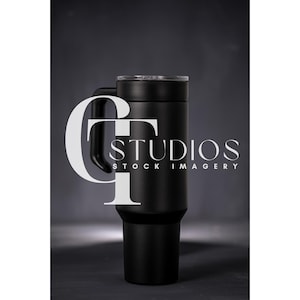 May include: A black stainless steel travel mug with a lid and a handle. The mug is on a dark gray background.