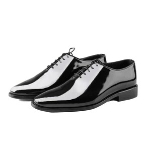 May include: A pair of black leather lace-up shoes with a polished finish.