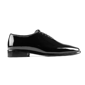 May include: Black leather lace-up dress shoes with a polished finish.