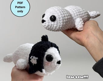 May include: Two crocheted seal plushies. One is white with black eyes and the other is white with a black crocheted hat and black eyes. The text "low sew!!!" is written below the plushies.