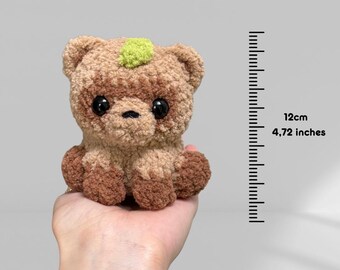 ローソーたぬきかぎ針編みパターン |たぬきの尾を持つ座っているタヌキ