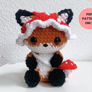 May include: Crochet pattern for a cute fox wearing a red and white mushroom hat. The pattern is available as a PDF download.
