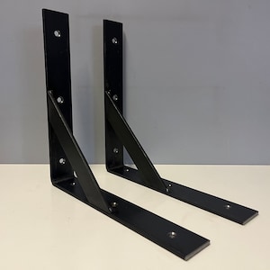 May include: Two black metal shelf brackets with angled supports and multiple screw holes.