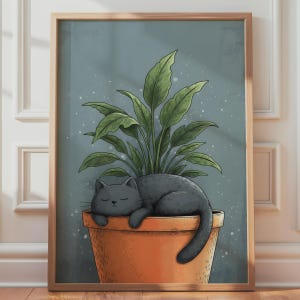 May include: A framed wall art print featuring a dark gray cat sleeping inside a terracotta-colored plant pot. A green leafy plant grows from the pot behind the cat. The background is a muted blue-gray color with small white speckles.