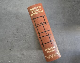 Historia de la filosofía occidental, de Bertrand Russell - Libro de tapa dura en piel, edición vintage dorada de 2004.