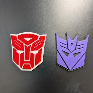 3D Printed Retro Robot Faction Magnets | Alien Robot Shield Fridge Magnet | 80s Cartoon Nostalgia Decor, Geeky Magnet, Sci-Fi Man Cave