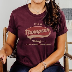 May include: A maroon t-shirt with a vintage-style graphic that reads "It's a Thompson Thing... You Wouldn't Understand".