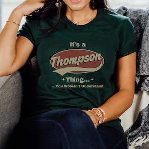 May include: A green t-shirt with a vintage-style logo that says "It's a Thompson Thing... You Wouldn't Understand".