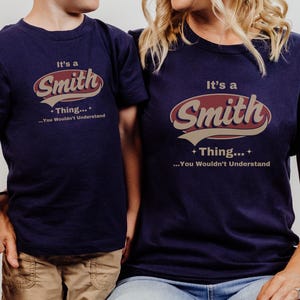 May include: Two navy blue t-shirts with a vintage-style graphic that says "It's a Smith Thing... You Wouldn't Understand".