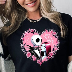 May include: Black t-shirt with a pink heart graphic featuring Jack Skellington and Sally from The Nightmare Before Christmas. The text "Love You To Death" is inside the heart.