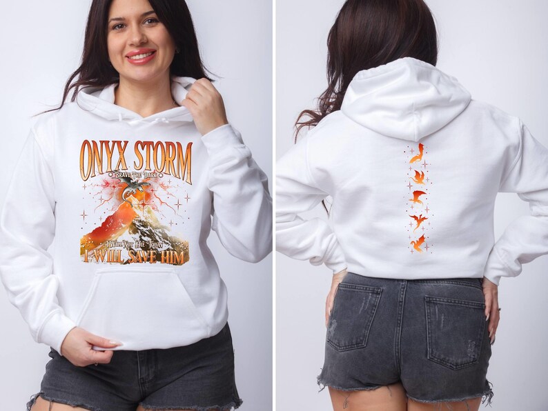 May include: White hoodie with a graphic print of a dragon and the text "ONYX STORM" and "I WILL SAVE HIM". The back of the hoodie has a vertical row of five orange birds.