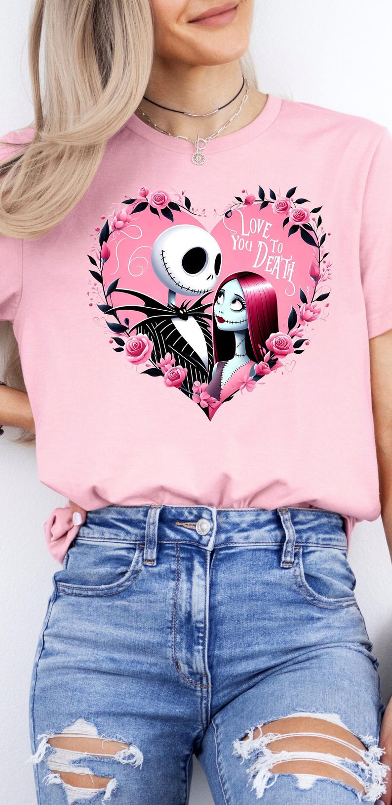May include: Pink t-shirt with a graphic of Jack Skellington and Sally from The Nightmare Before Christmas. The graphic is in a heart shape with pink roses and the text "Love You To Death".