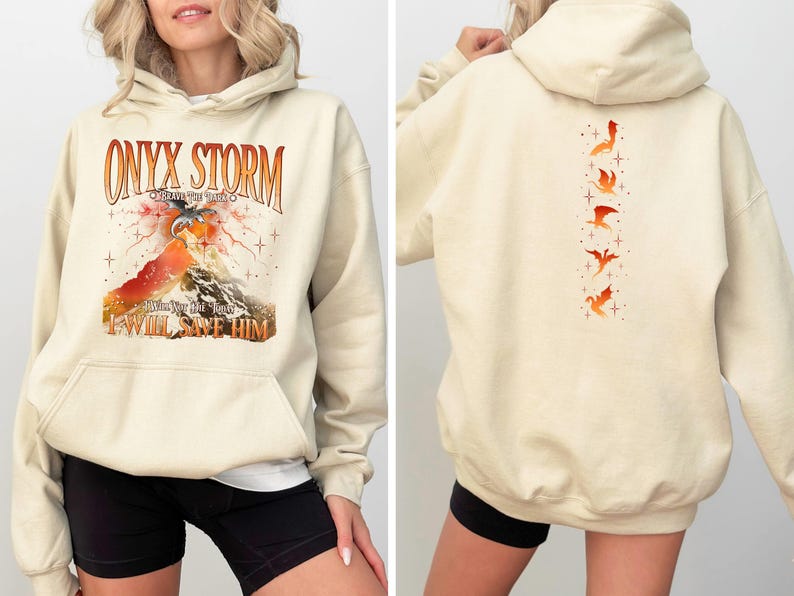 May include: A cream-colored hoodie with a graphic print of a dragon and the text "ONYX STORM" and "I WILL SAVE HIM". The back of the hoodie has a vertical line of five orange dragon silhouettes.