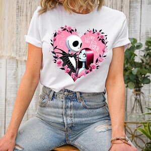May include: White t-shirt with a pink heart graphic featuring Jack Skellington and Sally from The Nightmare Before Christmas. The graphic includes the text "Love You To Death".