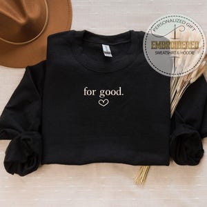 May include: Black sweatshirt with the text "for good." embroidered in white with a small heart symbol.