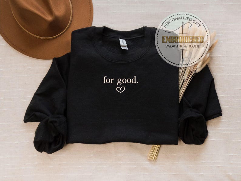 May include: Black sweatshirt with the text "for good." embroidered in white with a small heart symbol.
