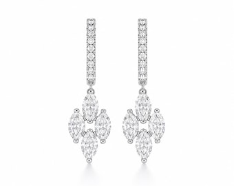 May include: A pair of silver-toned drop earrings featuring a vertical row of small round stones leading to a cluster of four marquise-cut stones arranged in a diamond shape. The metal setting is polished and bright, showcasing clear, faceted stones.