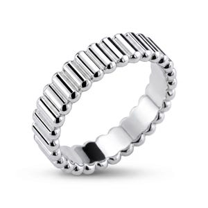 Angled view of a PT950 platinum ribbed band ring on a white background, emphasizing sculpted linear texture