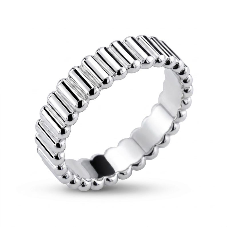 Angled view of a PT950 platinum ribbed band ring on a white background, emphasizing sculpted linear texture
