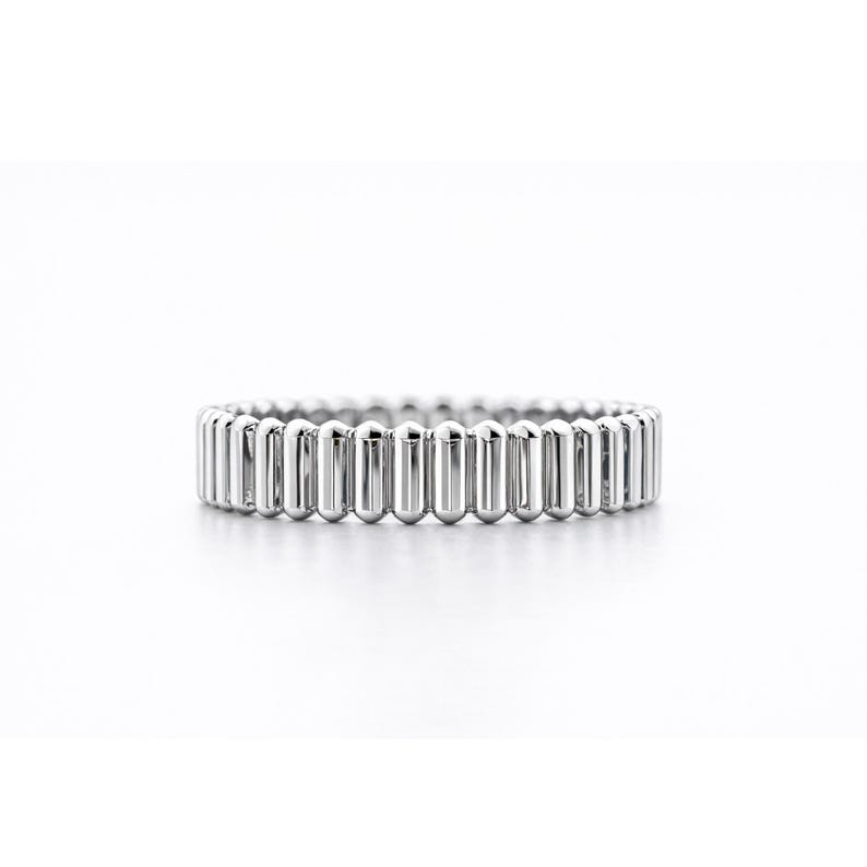 PT950 platinum ribbed band ring on a white background, showing a 4mm wide linear textured design with polished finish