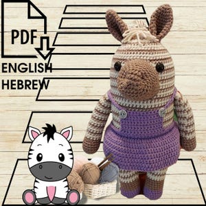 May include: A crocheted zebra toy wearing a purple dress with white buttons. The zebra has brown and white stripes and black eyes. The toy is sitting on a wooden surface with yarn and a basket.