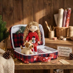 May include: A handmade Christmas doll with long blonde hair, wearing a red sweater with a snowman design, stands in a red and black plaid suitcase. A stuffed dog sits beside the doll. The suitcase has a red floral ribbon.
