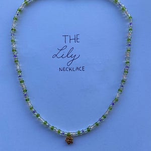 The Lily Necklace // Beaded necklace inspired by the flower Lily and colours, purple, white, green and a soft pink with a small leaf