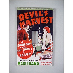 May include: Vintage light switch cover with a retro illustration. The artwork features the text "Devil's Harvest" and "The Truth About Marijuana." It depicts a man and woman smoking, with the phrase "A Good Girl Until She Lights a Reefer."