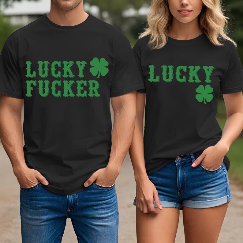May include: Black t-shirts with green text and shamrock designs. One shirt reads "LUCKY FUCKER", the other reads "LUCKY". Both shirts are paired with blue denim bottoms. The shirts are likely for St. Patrick's Day.