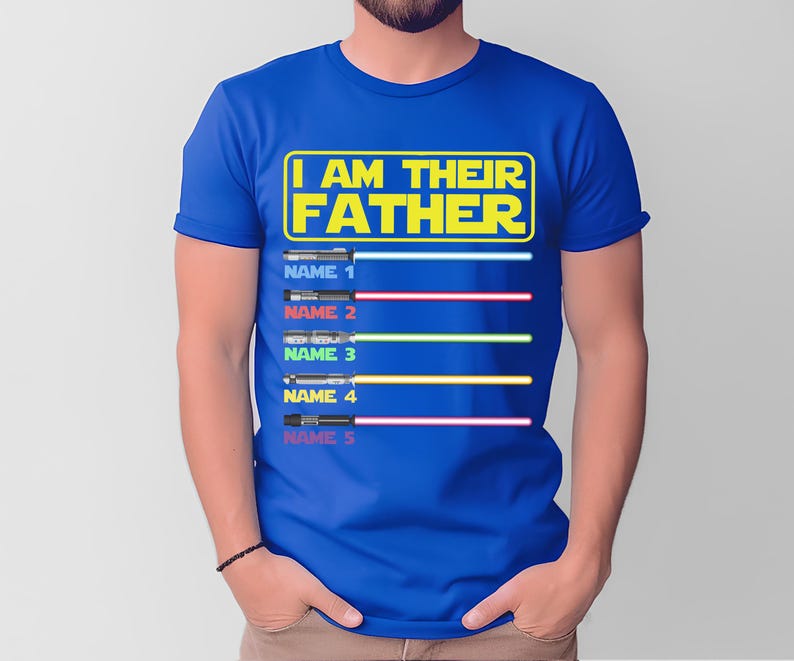 May include: Blue t-shirt with the text "I AM THEIR FATHER" in yellow. Below the text are five lightsaber designs with space for names. The lightsabers have different colored blades: blue, red, green, yellow, and pink.