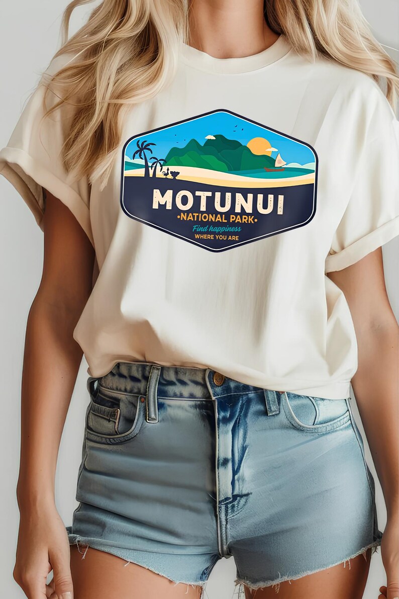 May include: Off-white t-shirt with a vibrant graphic depicting a tropical island landscape. The design includes the text "MOTUNUI NATIONAL PARK. Find happiness WHERE YOU ARE", palm trees, mountains, and a setting sun.