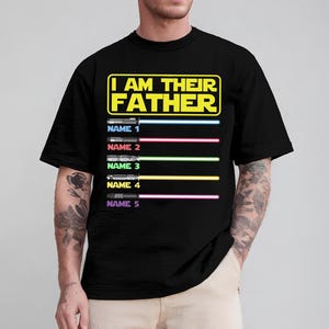 May include: Black t-shirt with the text "I AM THEIR FATHER" in yellow and white. Below the text are five light saber designs with the names 1 through 5. Each light saber has a different color.