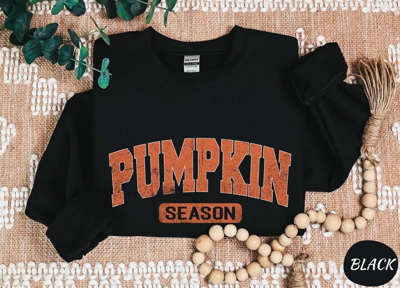a black shirt with a pumpkin design on it