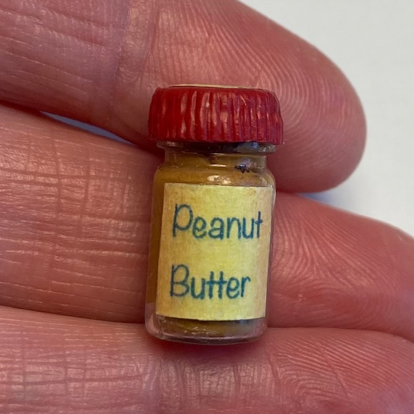 Miniature, handmade, glass jar of simulated, creamy peanut butter with removable lid for dioramas and displays.