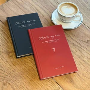 Two books titled "Letters to my mom" and "All the things I wish I could tell you" are placed on a wooden table next to a cup of coffee.