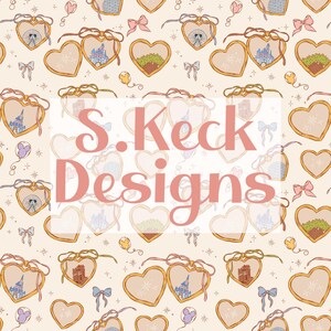 May include: A repeating pattern featuring heart-shaped lockets with various illustrations, including a castle, a park, and a character. The lockets are adorned with ribbons and bows, set against a cream background. The text "S. Keck Designs" is overlaid.