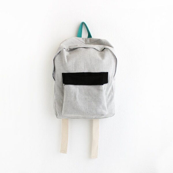 light grey denim backpack with black pouch