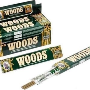 May include: A box of Woods natural incense sticks with a green and gold design. The box has the words "Woods" printed on it in a large, bold font. The incense sticks are packaged in a clear plastic wrapper.