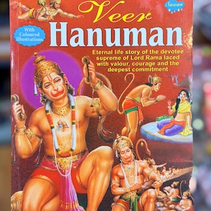 May include: A book cover titled "Veer Hanuman" with colorful illustrations. The cover features images of Hanuman, a Hindu deity, in various poses, adorned with jewelry and traditional clothing. Text includes "Eternal life story of the devotee supreme of Lord Rama."