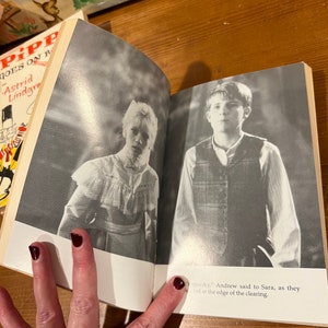 May include: An open book with a black and white photo of a young girl on the left page and a young boy on the right page. The text on the right page reads "spooky," Andrew said to Sara, as they stood at the edge of the clearing."