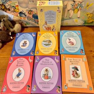 May include: A collection of Beatrix Potter books, including "The Tale of Peter Rabbit" and "The Tale of Benjamin Bunny." The books have colorful covers and illustrations. A matching box set is also present, featuring the title "The Original Peter Rabbit and Friends Collection."
