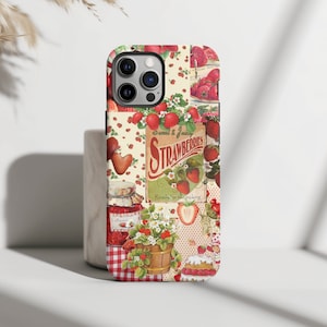 May include: A phone case with a collage of strawberries, jars of jam, and a basket of strawberries. The text on the case reads "Sweet & Juicy Strawberries Ready for the picking".