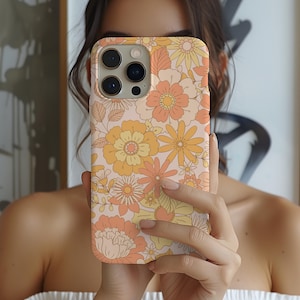 May include: A pink and orange floral phone case with a retro design. The case has a cutout for the camera lens and buttons.